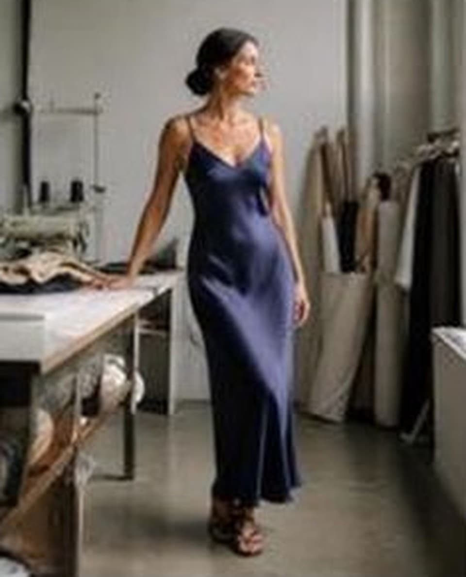 Navy satin cowl-neck slip dress, worn